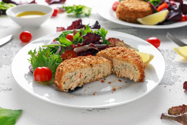Home made Fish Cake salmon, spinach and potato. served on plate with vegetables