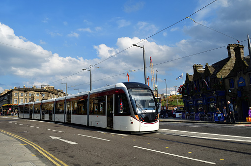 Belfast, UK. 12 August 2022. Bus drives by Belfast City Hall in the city centre