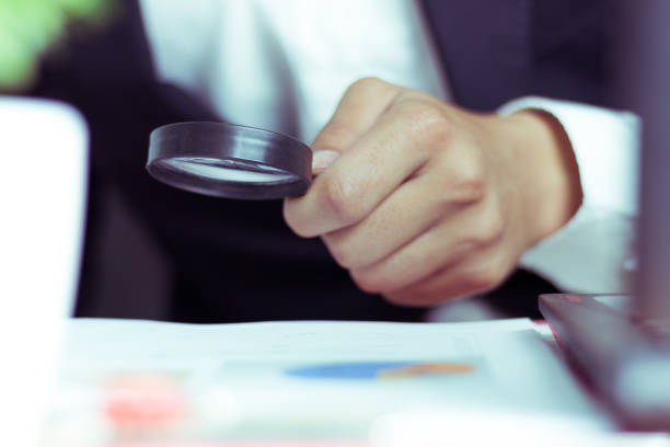 istock Businessmen use a magnifying glass to analyze the company's data and statistics from the chart. 1019871390