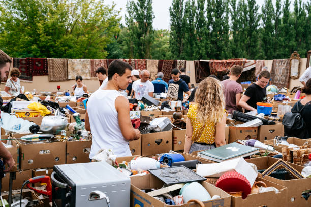People walking and buying various items at the Mauerpark  flea market. Mauerpark is a public park in the Prenzlauer Berg district. Flea market in Mauerpark is frequently used as sunday afternoon activity by hip Berliners and tourists. The flea market itself consists of mainly private salespersons who offer various items.