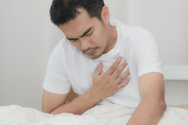 istock Asian man has chest pain while lying on the bed in bedroom 1019886368