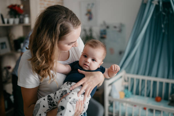 istock Mom holding her baby in a nursery 1019889886