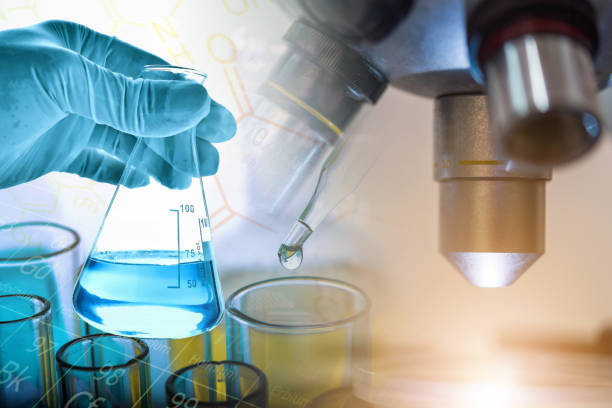 istock Flask in scientist hand and lab glassware background with microscope, science and chemical research and development concept 1019890310