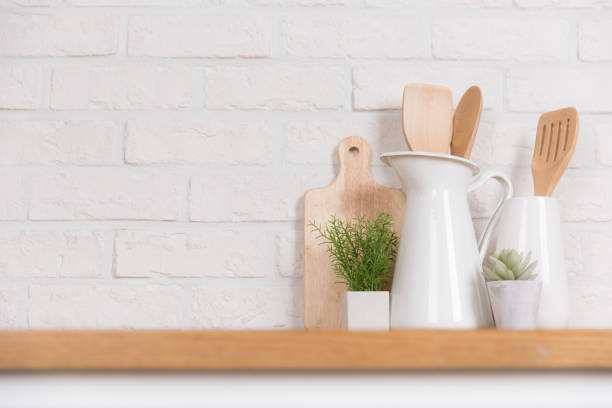 istock Kitchen utensils and dishware on wooden shelf. Kitchen interior background.Text space. 1019895330