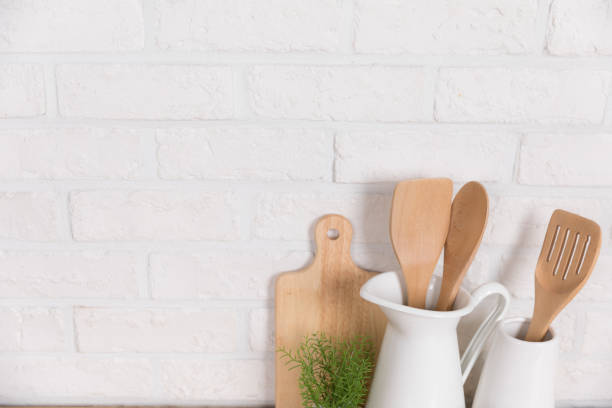 istock Kitchen utensils and dishware on wooden shelf. Kitchen interior background.Text space. 1019895356