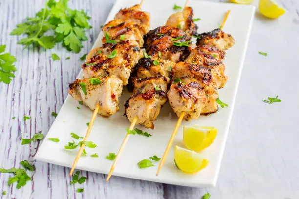 Chicken Kebabs on Skewers Served on a White Plate