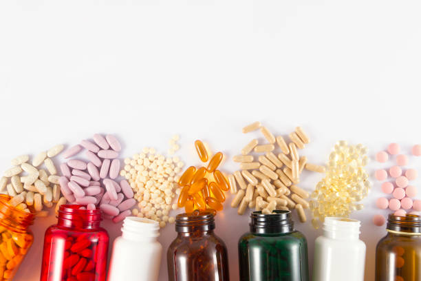 pílulas fundo - vitamin a nutritional supplement pill capsule - fotografias e filmes do acervo