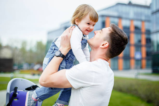 istock Young dad sits a small daughter in a chair before riding a bicycle. 1019913676