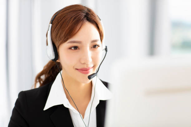 istock beautiful young business woman operator in headset 1019917192