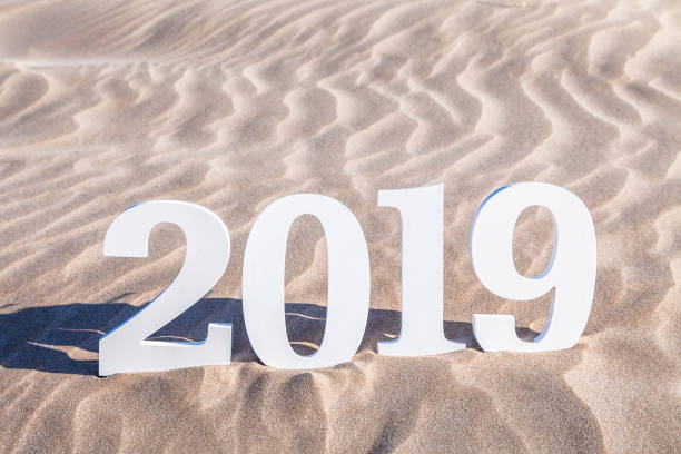 istock Year 2019 white numbers on beach sand 1019918098