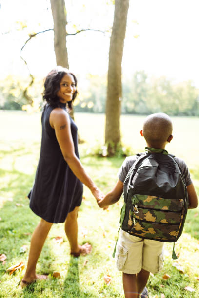 istock mom take the son back to school 1019922654