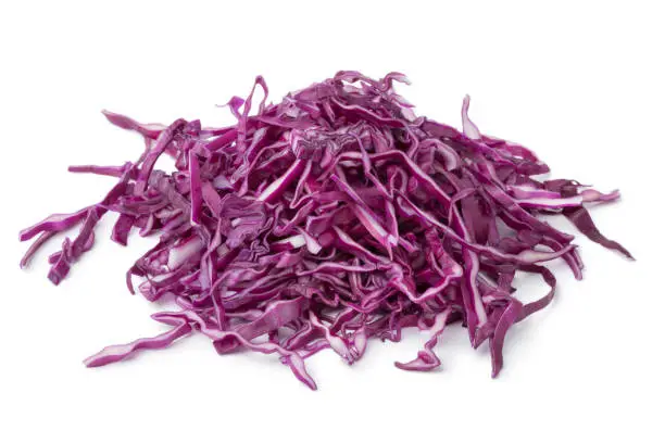 Heap of fresh raw shredded red cabbage isolated on white background