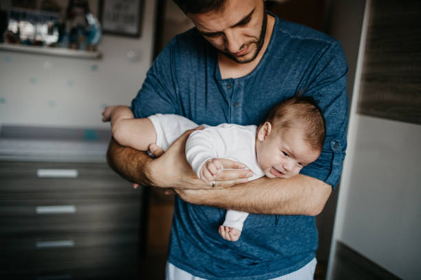 istock Dad Holding crying baby in the colic carry 1019929436