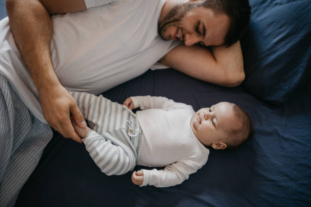 istock Father playing in bed with his little baby boy 1019932148