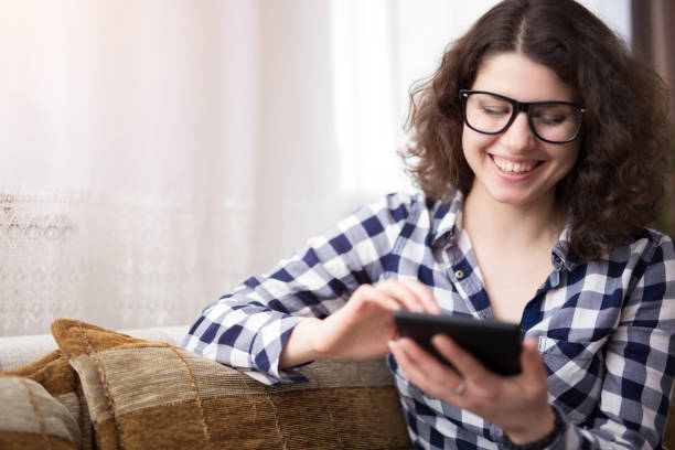 istock Woman sitting on bed and using her tablet . 1019933068