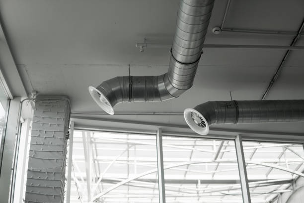 istock Ventilation system on the ceiling of large buildings. Ventilation pipes in silver insulation material hanging from the ceiling inside new building. 1019944896