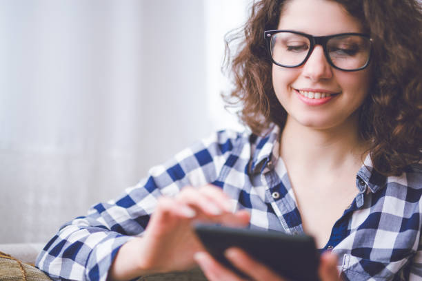 istock Happy young woman using tablet indoor. 1019946214
