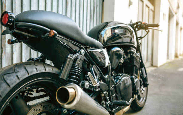 Back view of customized motorcycle Back view of customized motorcycle parked in front of garage door helicopter seat stock pictures, royalty-free photos & images