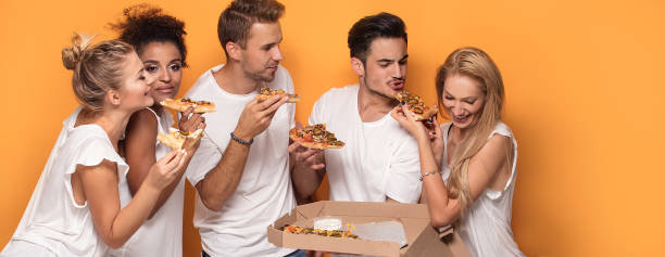 istock Multiracial people having fun, eating pizza. 1019948832