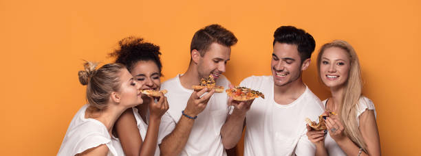 istock Multiracial people having fun, eating pizza. 1019948890
