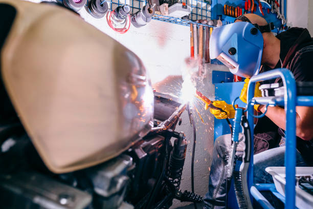 istock Motorcycle mechanic welding in the workshop 1019948924