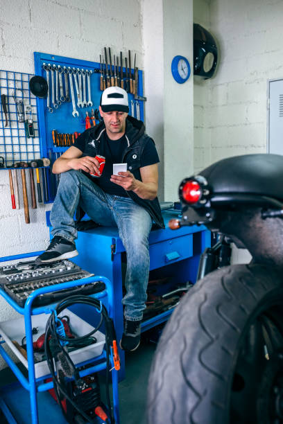 istock Motorcycles mechanic resting having a beer 1019949054