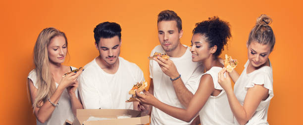 istock Multiracial people having fun, eating pizza. 1019949088