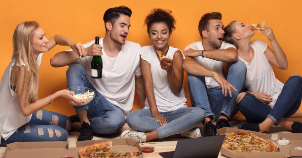 istock Multiracial people having fun, eating pizza. 1019949152