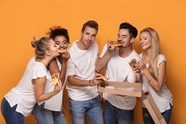 istock Multiracial people having fun, eating pizza. 1019949212