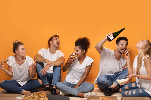 Multiracial people having fun, eating pizza.