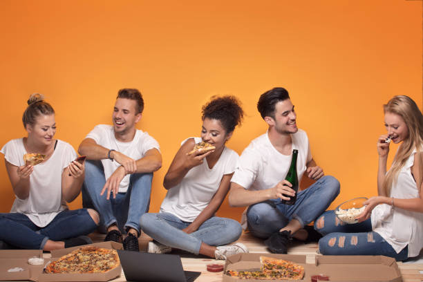 istock Multiracial people having fun, eating pizza. 1019949272