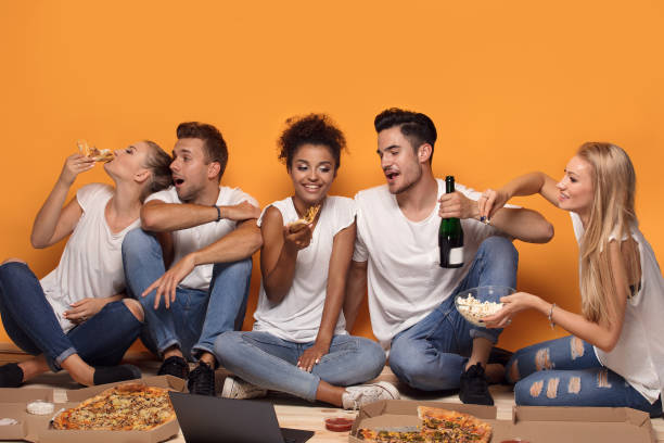 istock Multiracial people having fun, eating pizza. 1019949352