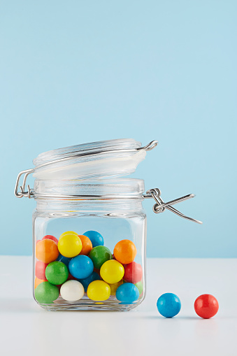 Close up shot of colored bubble gums in a jar.