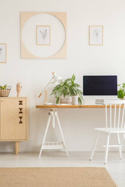 istock White chair at desk with desktop computer in workspace interior with plants. Real photo 1019950950