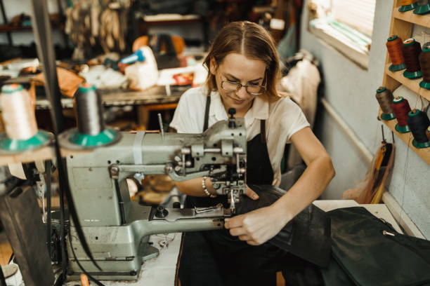 istock Beautiful woman sewing leather materials in the workshop 1019954660