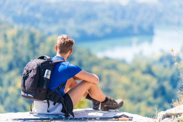 istock Happy hiker enjoy the view on mountain top rock 1019957734