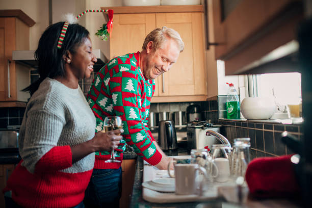 istock Laughing with her Husband as he Washes the Dishes at Christmas 1019958548