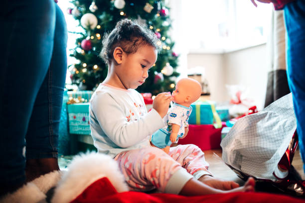 istock Girl Playing with a Doll she's Received for Christmas 1019963866