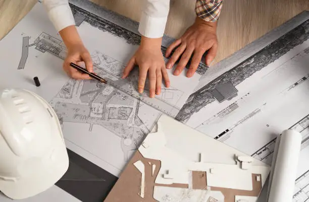 Photo of Architects Working with Blueprints