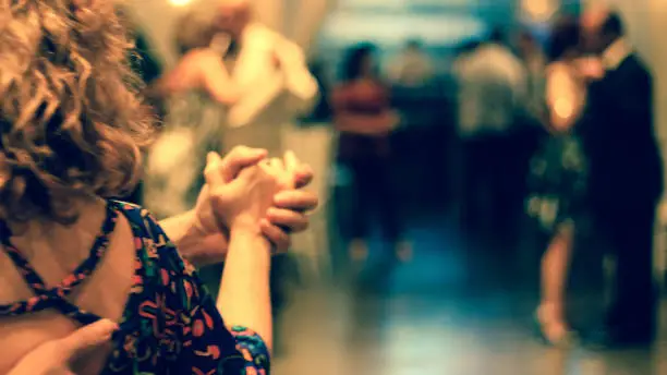 Couple holding hands dancing tango