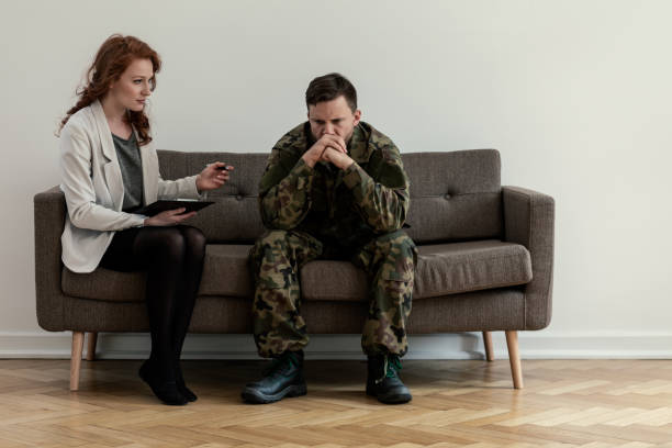 istock Psychiatrist talking to her angry patient while sitting on a sofa 1019966998