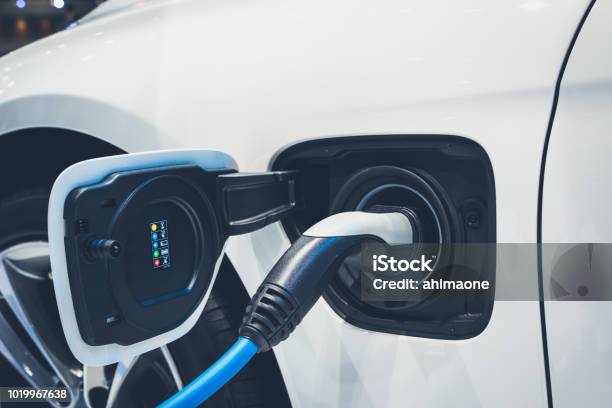 The Process Of Charging An Electric Vehicle Electric Car Socket For Background Stock Photo - Download Image Now