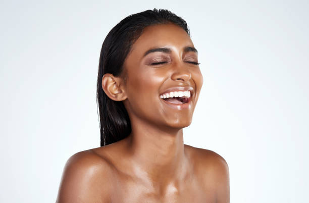 Laughter is the best facial exercise Studio shot of a beautiful young woman posing against a light background indian woman laughing stock pictures, royalty-free photos & images