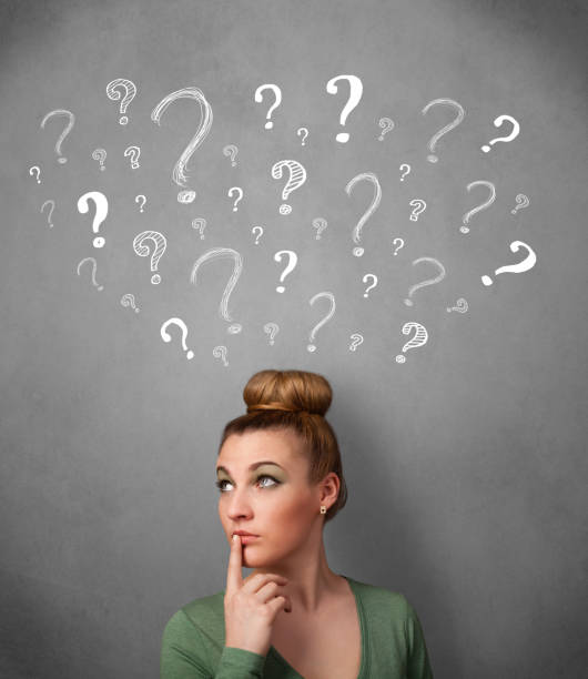 istock Young woman with question marks above her head 1019968312
