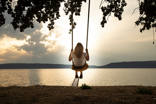 Woman on a Beautiful Swing by a River