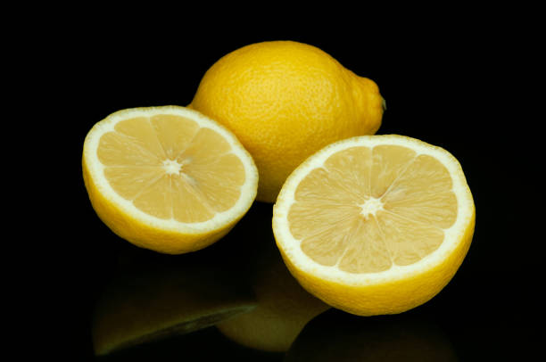 istock Sour lemon isolated on black background 1019983298