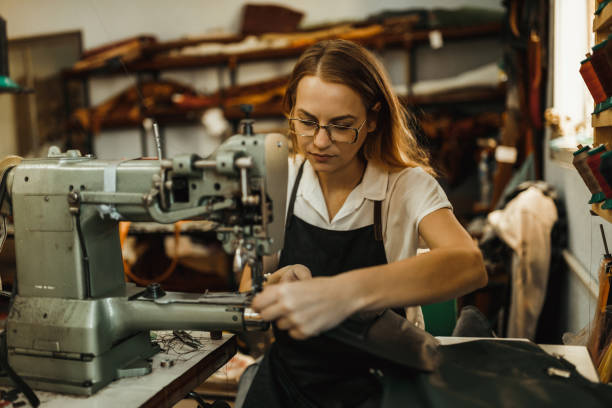 istock Beautiful woman sewing leather materials in the workshop 1019989718