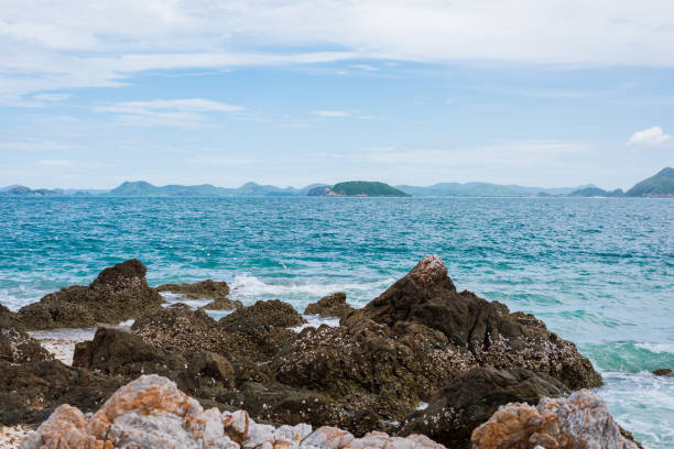 Rocky coast and sand beach with blue sea on KohKham. Sattahip, Chonburi, Thailand
