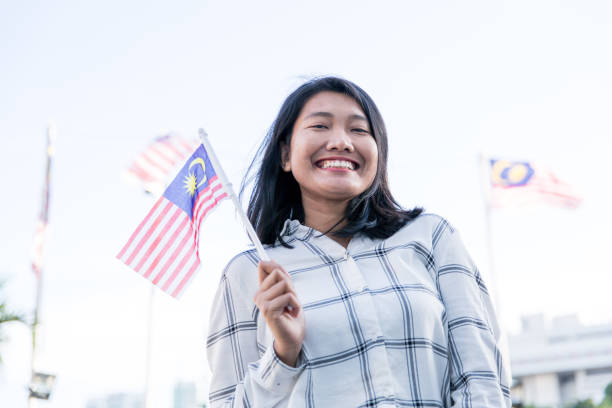 istock One girl holding Malaysian Flag 1019995140