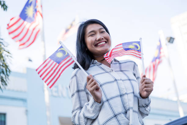 istock One girl holding Malaysian Flag 1019995192